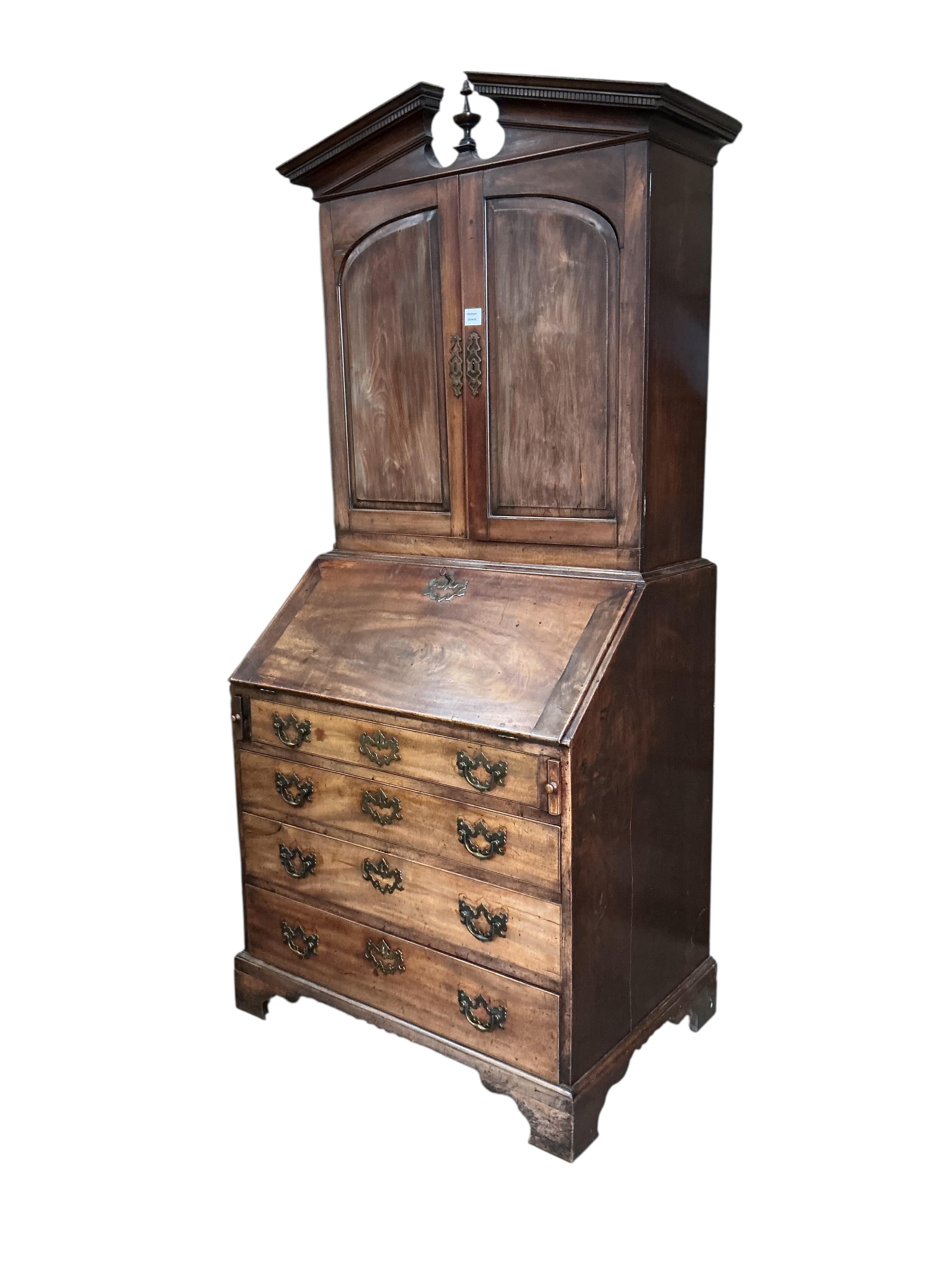 A small George III mahogany bureau cabinet with broken arch pediment, width 95cm, depth 62cm, height 198cm
